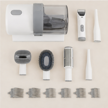 Complete pet grooming vacuum kit laid out: base unit with 2.5 litre clear container, hair clipper, crevice tool, four attachment heads and six clipping guide combs