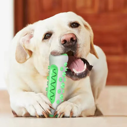 Yellow Labrador lying down and chewing the green textured chew toy