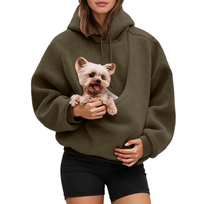 Person wearing the olive fleece pouch hoodie with a small terrier held in the front pouch