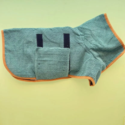 Green dog bathrobe with orange trim laid flat, showing the fold-under chest panel and straps